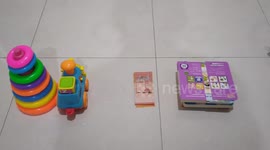 This toddler is more impress the kitchenware than toys, money and books