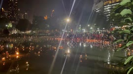 Locals release boat lanterns in canal for Loy Krathong celebration in Thailand