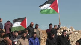 Palestinians perform Friday prayers on al-Ras land, which is threatened with confiscation by the Israeli authorities, in Qalandiya, in the West Bank