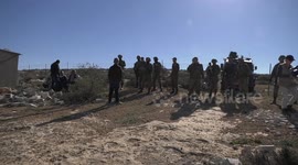 Palestinian land owners trudge through as Israeli security forces evacuate protesters in West Bank
