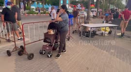 Loving pet owner carries Pomeranian dog on baby stroller