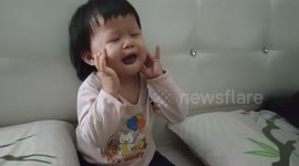 Hilarious toddler makes funny face to cheer up her parents and sibling