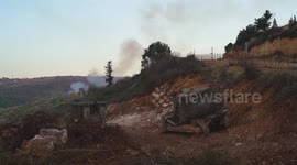 Israeli military bulldozers belonging to the Israeli army work near the fence at the Lebanese border