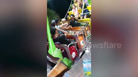 Pirate ship fairground ride operated by a guy sitting under carriage pushing lever