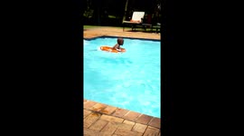 Kids in the pool. My grandson Uyanda learning to swim with a tube. A funny thing to watch.