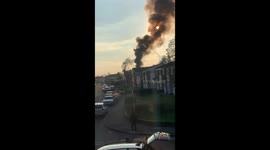 Flat on fire. Black smoke coming out of the building and over 60 fire fighters came rushing along with police cars.