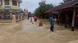 Children seen enjoying swimming in floodwater in inundated Indonesian village