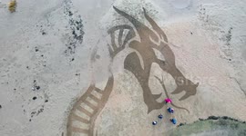 Artist swaps paint brush for a garden rake to create 100ft-long sea serpent
