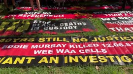Protesters stand for what is introduced as the Aboriginal national anthem at Invasion Day protest in Sydney, Australia