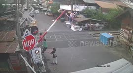 Shocking moment children play on level crossing barrier as train passes