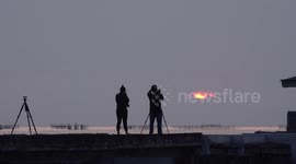Photographers capture unusual sunset emerging through cloudy sky in Thailand