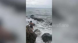 Tourist knocked over by massive wave in amusing beach photo fail