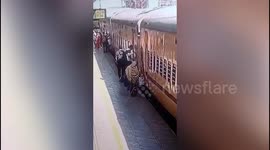 Crime Branch officers save life of woman who fell while boarding moving train in western India