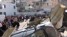 Palestinians inspect the building damaged and burned by Israeli troops during a raid, in the West Bank city of Jenin