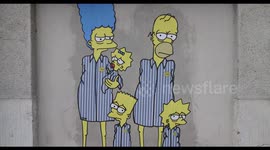 Mural of Simpsons dressed as Auschwitz prisoners appears on Milan train platform where thousands were deported to concentration camps