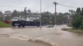 Bus powers through flooded road in Auckland, New Zealand