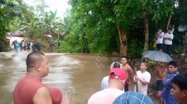 Residents battle through raging river as bridge collapses in the Philippines floods