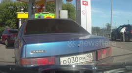 Accident Car Reverses and Crashes into the Car Behind at a Gas Station
