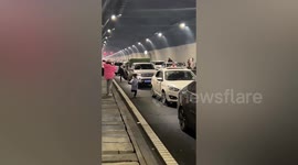Travellers exercise on highway while stuck in traffic in China