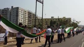 Nearly 7 miles of 15,000 volunteers come together to break world record for longest human FLAG
