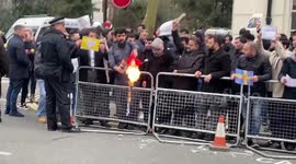 Angry muslim protesters burn swedish and danish flags outside London embassy