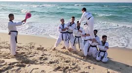 Palestinian taekwondo players take part in training exercises on the shore of the Mediterranean