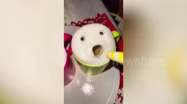 Funny frothy coffee with googly eyes makes wacky faces when blown