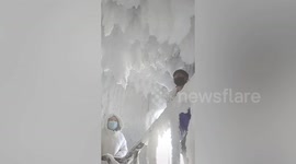 In China, an apartment block's corridor turned into a magical ice castle when a person left a door open