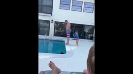 The child attempts to push his father into the pool, and he ends up falling in too