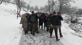 Police transport patient with pneumonia across snow-covered Jammu and Kashmir