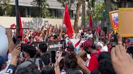 Protesters hold pictures of Aung San Suu Kyi at rally against military coup