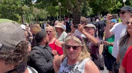 Protesters heckle as the funeral procession for Cardinal George Pell leaves St Mary’s Cathedral in Sydney, Australia