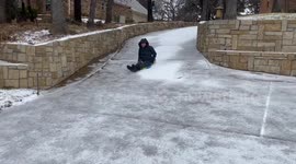 US: Sledding Down Frozen Driveway In Colleyville, Texas
