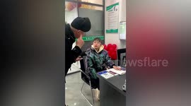 Chinese girl speaks to father for first after having hearing aid fitted