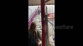 Barefoot travelers brave flooded stairs at metro station in Paris