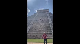Man walks up the Mayan ruins on Mexico's Yucatán Peninsula