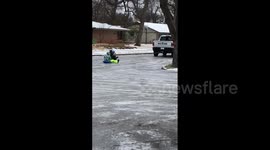 Texans enjoy sledding down ice-covered roads