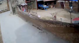Strong winds blow over courtyard’s brick wall in China