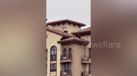 Terrifying scene as children spotted playing on high-rise building's roof in China