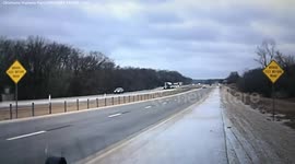 Semi truck loses control in icy conditions and careers into oncoming traffic narrowly avoiding a collision