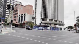 An excavator operator creating a racket in downtown Auckland New Zealand as they repeatably bang the bucket of a excavator against a section of a building they are attempting to demolish.