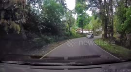 Almost crashes as car in front take the road around the corner