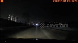 An unidentified object lights up the sky, caught by a car dash cam