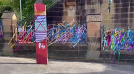 Victims and survivors of clergy abuse tie a ribbon in front of St. Mary's Cathedral in Sydney