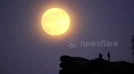 Skygazers watch full snow moon rise over Black Rocks in Derbyshire's Peak District
