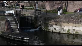 People walking past the St Pancras Basin Dry Dock, London, United Kingdom