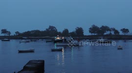 Lobster Boats All Lit Up In the Morning - One Boat Leaves Harbor