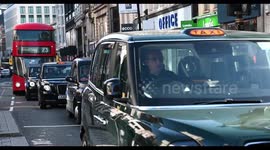 Three Taxi's and a Double Decker Bus coming through Oxford Circus, London, United Kingdom