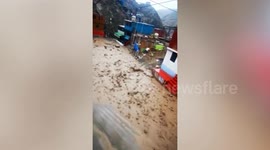 Flash flood roars down neighbourhood road in Peru