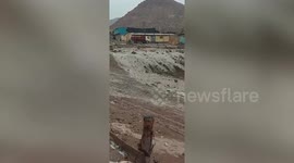 Muddy torrent cascades down road during floods killing at least 36 in Peru